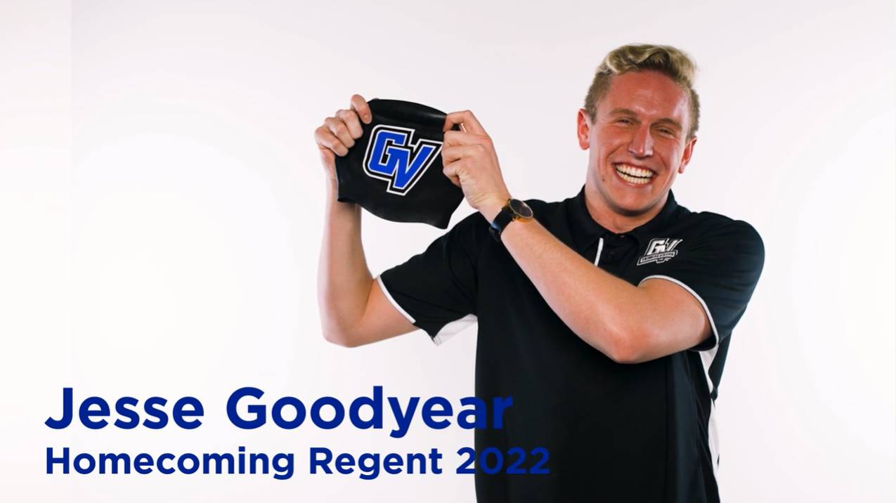 Jesse Goodyear, 2022 Homecoming Royal. Jesse is holding up a swim cap and smiling.